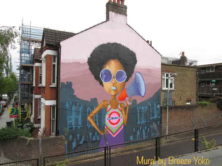 mural of black woman with megaphone on side of British house